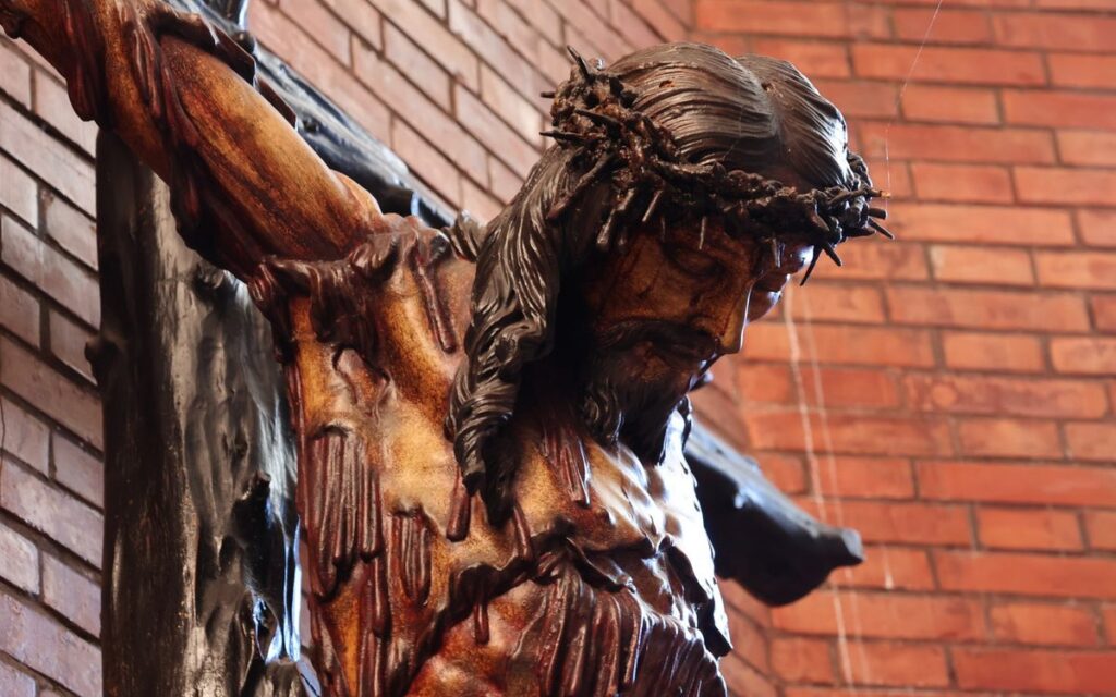 Detailed crucifix statue inside a historic church in El Puerto de Santa María.
