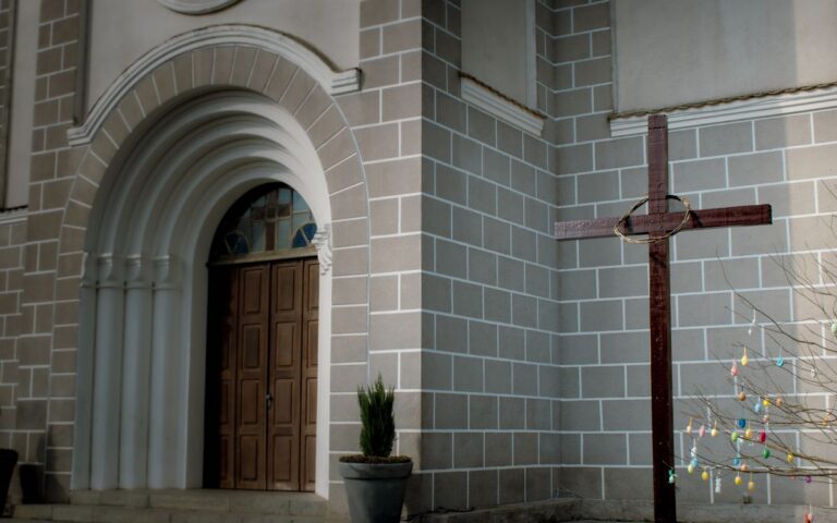 Beautiful church entrance with a wooden cross, representing faith and peace.