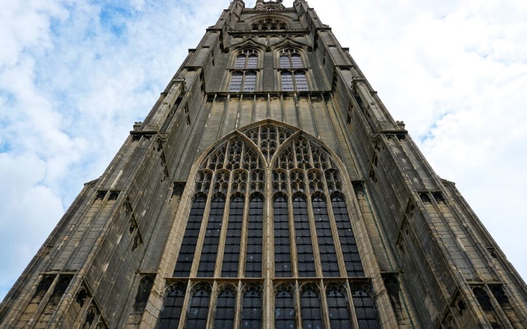 Low angle shot of a gothic tower facade in Boston, England, showcasing architectural grandeur.