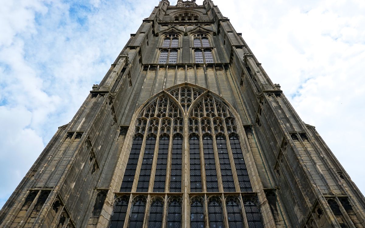 Low angle shot of a gothic tower facade in Boston, England, showcasing architectural grandeur.