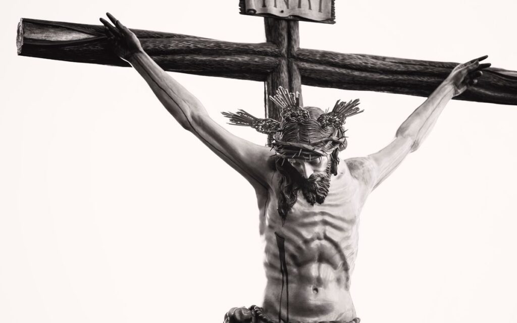 Monochrome depiction of Jesus crucified, showcasing religious artistry and sacrifice.