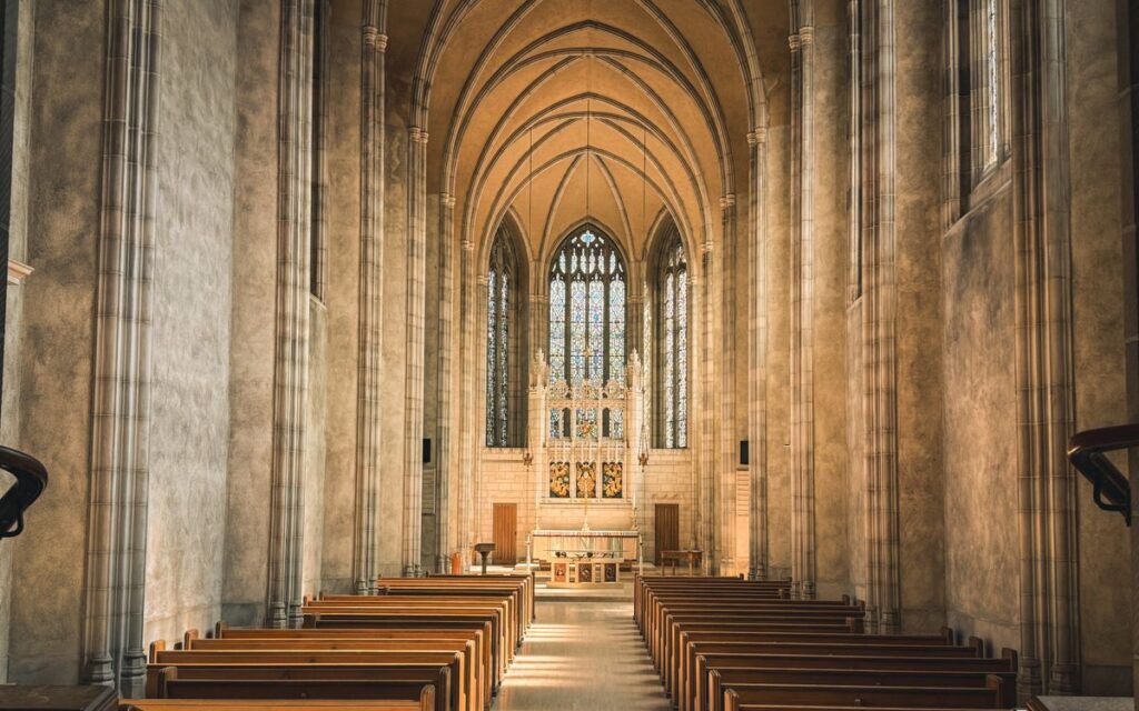 Serene Gothic cathedral interior with sun-drenched altar and empty pews in Toronto.