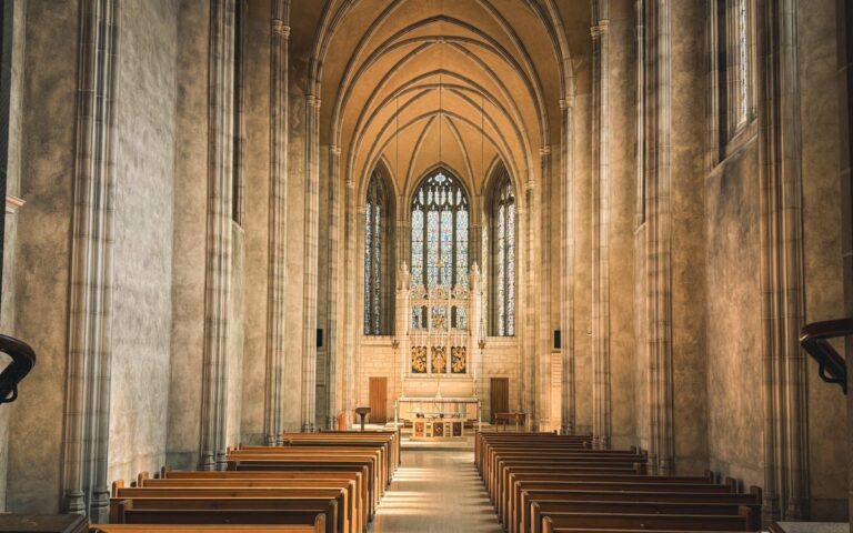 Serene Gothic cathedral interior with sun-drenched altar and empty pews in Toronto.