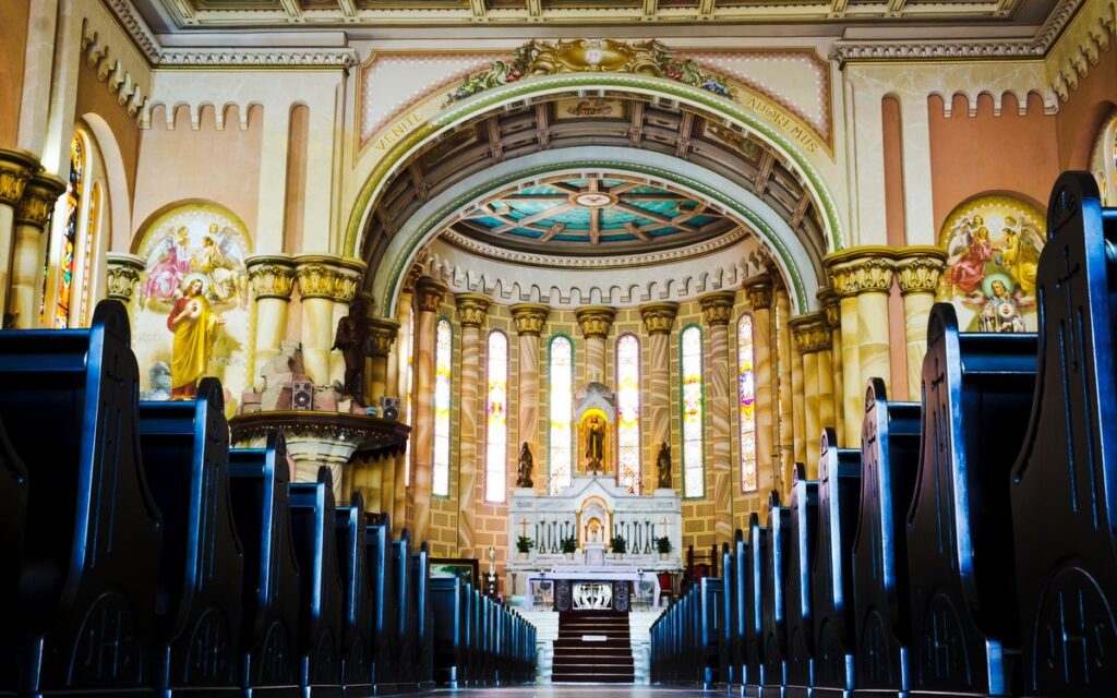 A beautifully ornate cathedral interior with stained glass and intricate architectural details.
