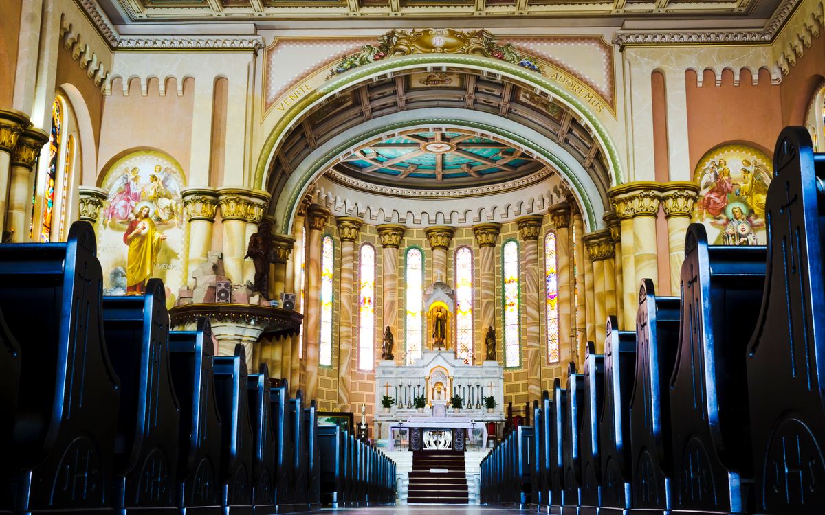 A beautifully ornate cathedral interior with stained glass and intricate architectural details.