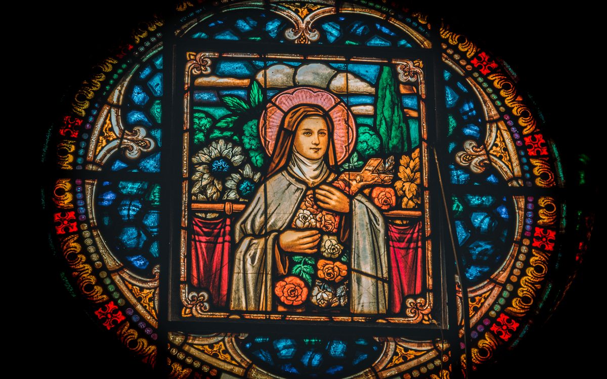 Detailed stained glass artwork featuring a religious figure with vibrant colors and intricate designs.