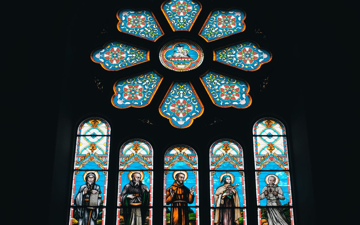 Colorful stained glass window depicting religious figures inside a church in China.