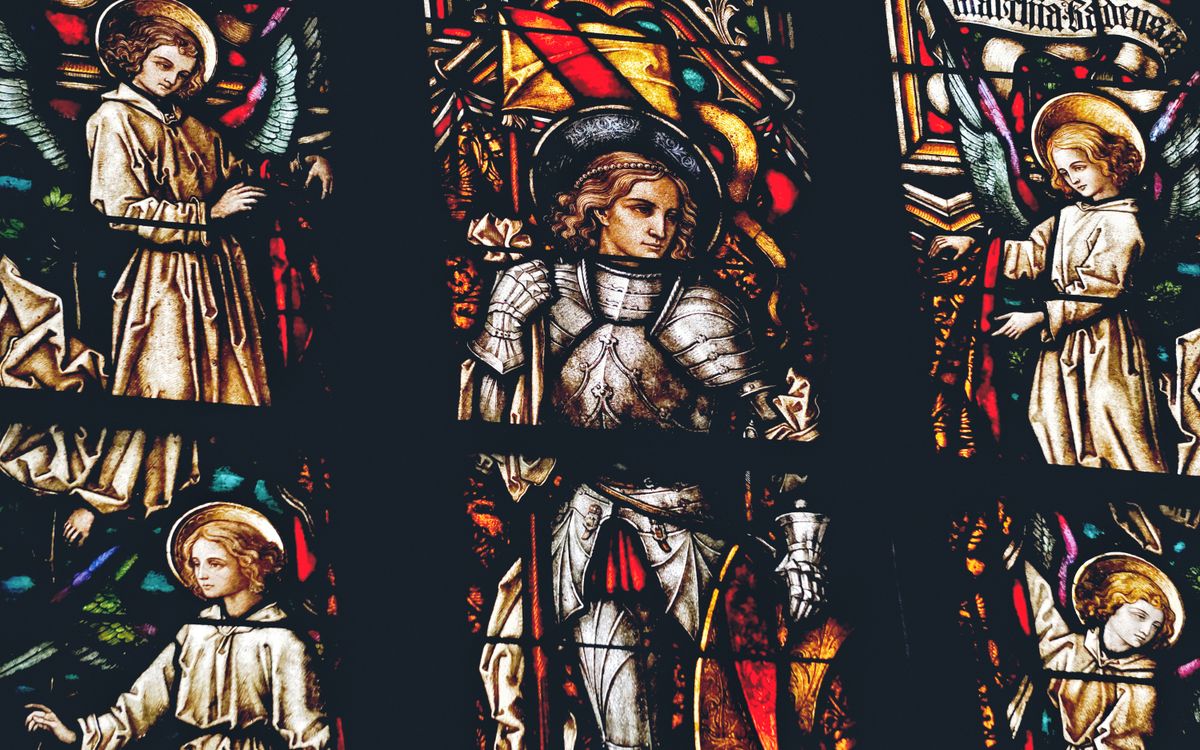 Beautiful stained glass depicting biblical scenes inside a Gothic cathedral.