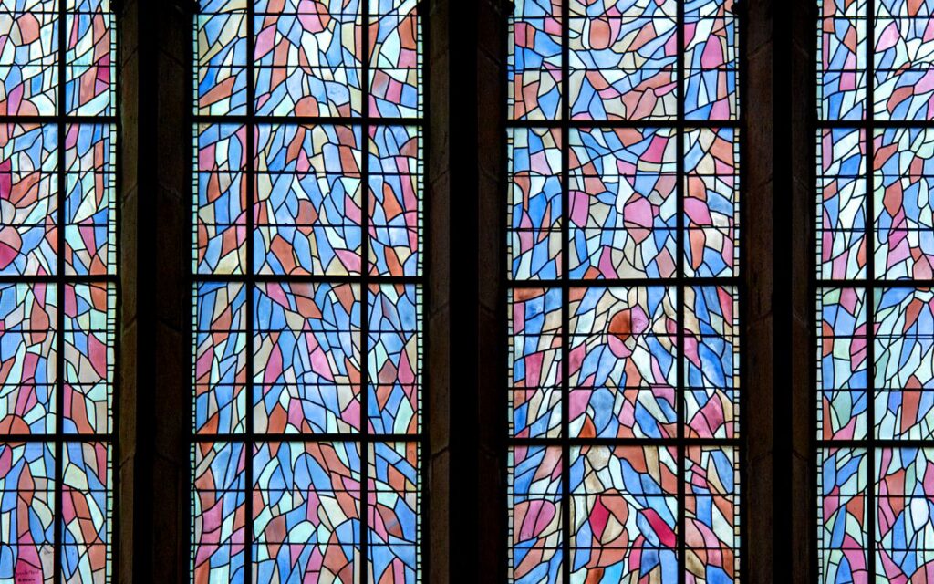 Vibrant stained glass art showcases intricate designs in church windows.