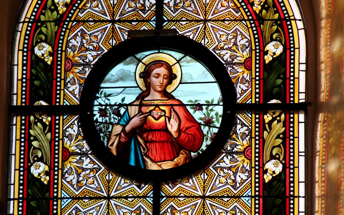 Stunning stained glass window depicting a saint in Klein-Mariazell, Austria's historic basilica.