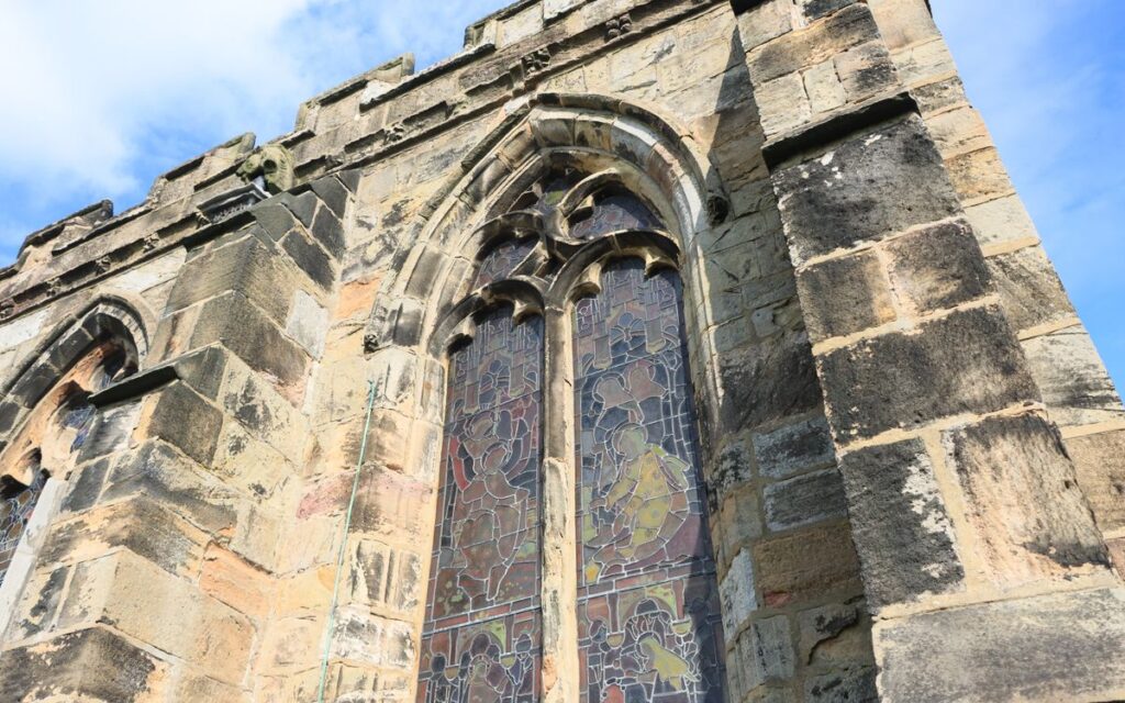 Close-up of a Gothic church window with stained glass in England.